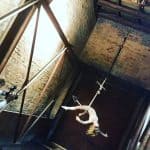 The vintage-style image captures the emotional moment of a performer suspended in mid-air, showcasin.