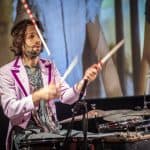 The vintage-style image captures the emotional energy of the drummer immersed in the music.