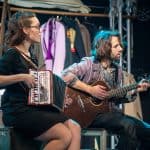 The vintage-inspired scene captures the heartfelt connection between the musicians and their instrum.