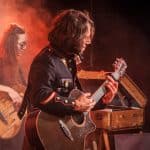 The vintage scene captures the emotional connection through music and nostalgic atmosphere.