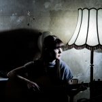 The vintage scene captures the emotional depth of the woman immersed in her music, illuminated by a.