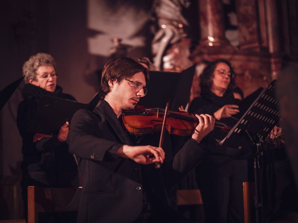 The emotional moment of the vintage-style string quartet playing passionately on stage.