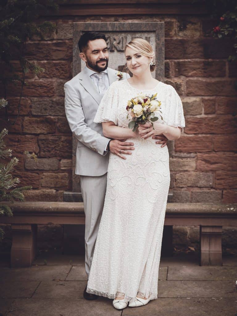A romantic vintage wedding scene featuring a bride and groom in classic attire, highlighting love and celebration.