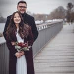 The vintage-inspired couple shares a heartfelt moment, embracing love and nostalgia against a serene.